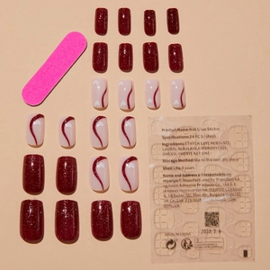 Press-on nail set with deep red glitter and blush heart designs, file and adhesive included