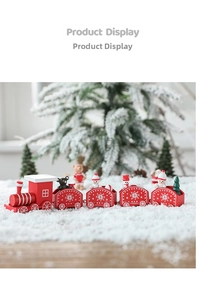 Detail of red wooden Christmas train with miniature snowman and bear on faux snow