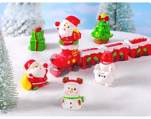 Miniature Christmas resin figurines set featuring Santa and snowman on snow background