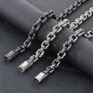 Macro shot of punk style stainless steel chains with hammered texture in three metal colors