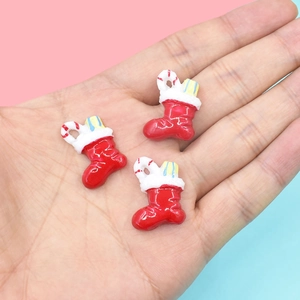 Miniature resin Christmas stockings held in hand for DIY dollhouse crafts and decor