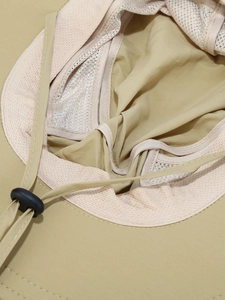 Detail of breathable mesh lining and adjustable chin strap on quick-dry sun hat