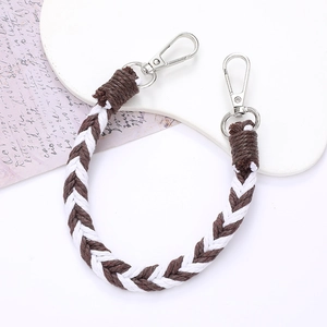 Detail of a brown and white woven phone strap with high-quality silver lobster clasps