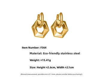Detailed view of geometric hexagonal drop earrings in polished gold stainless steel