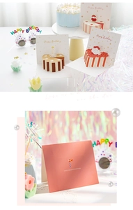 Macro shot of 3D pop-up birthday cake card with party glasses and candles set