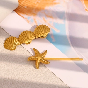 Detail of 18K gold plated starfish and scallop shell hair clips for women