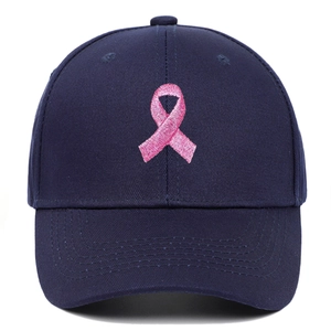Close-up of pink ribbon embroidery on navy blue baseball cap with high quality stitching