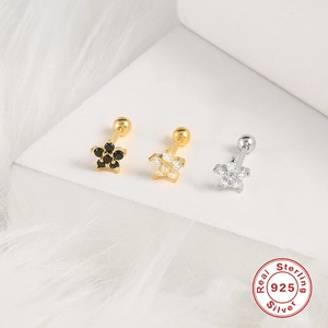 Detail of silver star earrings with gold plating and zircons on 925 sterling silver studs