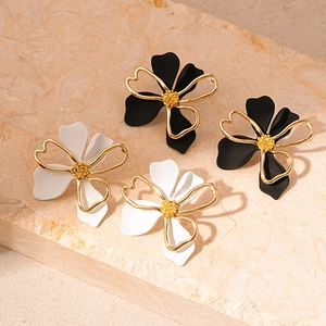 Minimalist double-layer floral stud earrings in black and white with gold accents