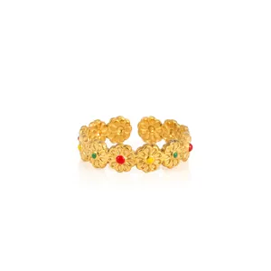 Detailed macro view of colorful enamel daisy flowers on adjustable gold plated steel ring