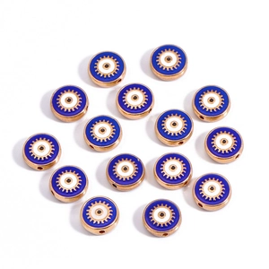 Macro detail of 10mm gold Evil Eye beads with blue enamel inlay for DIY jewelry making