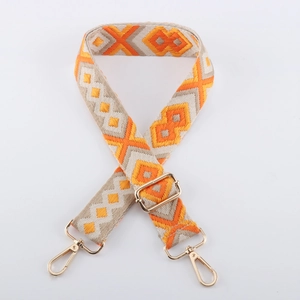 Detailed view of the orange and beige geometric woven strap with golden metal lobster clasps