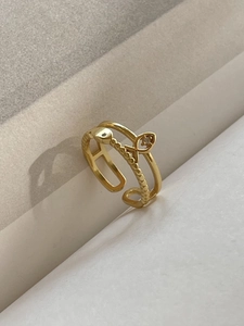 Detailed view of a gold fish-shaped sterling silver open ring with small sparkling crystals