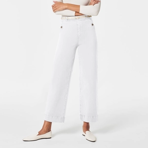 Detailed view of white wide-leg cropped denim trousers with slim belt on a model