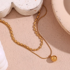 Detail of 18K gold-plated double-layer necklace with oval beads and sphere pendant