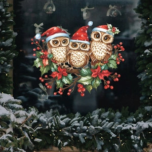 Christmas window stickers featuring three owls in hats with holly leaves on a snowy window