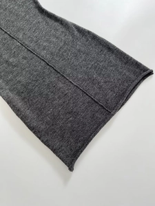 Close-up of grey knit dress cuff featuring soft texture and natural rolled edge design