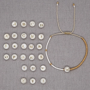 Bracciale minimalista in perline Miyuki placcato oro con lettera in conchiglia naturale