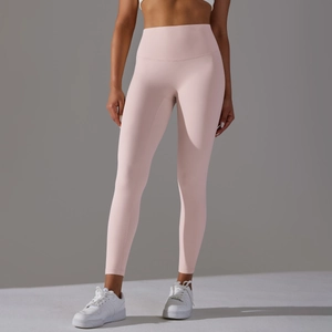 Close-up of seamless pale pink high-waisted yoga pants showing supportive compression fabric
