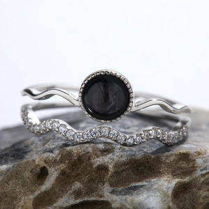 Macro shot of S925 silver rings with black gemstone and sparkling zircon accents