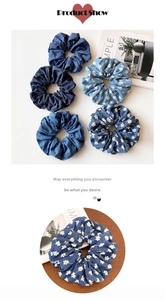 Detail of denim blue floral and solid elastic scrunchies with soft cotton texture