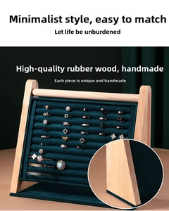 Detailed view of luxury green velvet ring slots and natural rubber wood jewelry tray