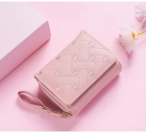 Pink quilted short wallet for women, featuring cute heart embroidery and compact wristlet design.