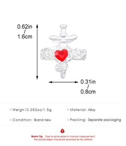 Detail showing dagger through heart design with red gemstone and rose relief