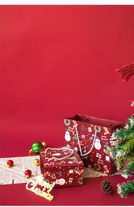 Festive red Merry Christmas paper gift bags with snowmen and decorative ornaments