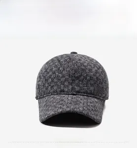 Detailed view of grey herringbone wool baseball cap featuring a vintage copper side logo