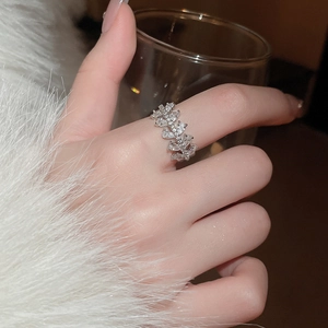 Detail of silver snowflake leaf ring with marquise zircons on model's finger