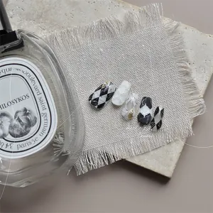 Macro detail of luxury embossed nail art featuring marble texture and checkerboard patterns