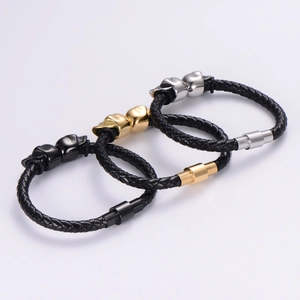 Classic punk leather bracelet with skull charms and magnetic clasp in black, gold, and silver