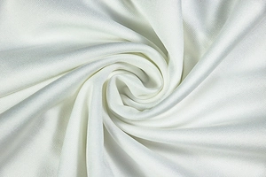 Macro shot of white woven fabric detail showing smooth texture and fine grid pattern