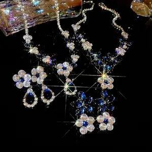 Sparkling zircon flower and leaf jewelry set with navy blue crystals on black background