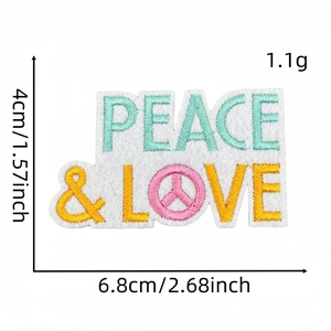 Macro shot of Peace & Love embroidered patch showing fine stitching and pink symbol
