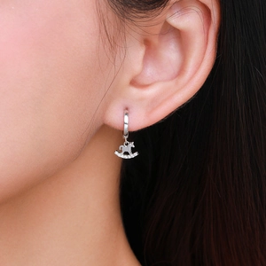 Elegant s925 silver rocking horse hoop earrings with sparkling rhinestones on model