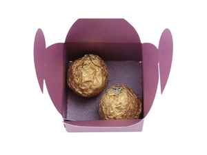 Detail of purple pearlescent paper candy box with gold foil chocolates inside