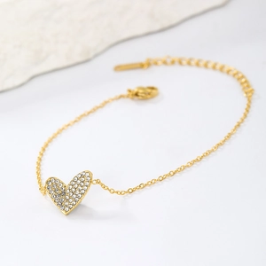 Detail of gold plated stainless steel heart bracelet featuring pavé-set cubic zirconia stones