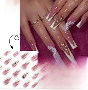 Detail of pink gradient French press-on nails with 3D flowers and golden glitter