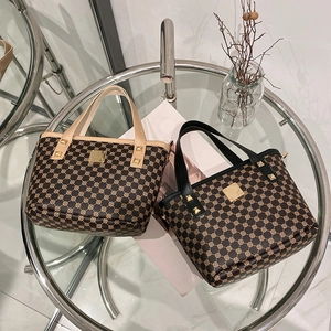 Retro printed bucket handbags in black and beige with gold metal plate and rivet details
