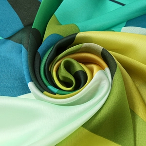 Detailed macro of vibrant geometric patterned satin scarf with premium silky texture