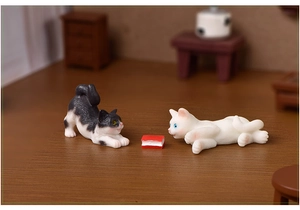 Macro detail of miniature resin cats and a small red book for micro landscape decor