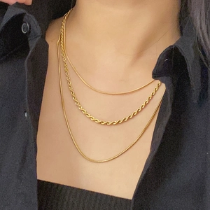 Three-layer 18K gold plated snake and twisted rope chain necklace on a model