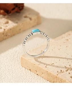 Macro detail of S925 sterling silver ring featuring a blue turquoise stone and side zircon accents