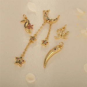 Gold-plated charms set with seahorse, moon star fringe, letter F and horn pendant with zircons