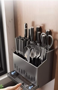 Detail of the removable translucent drain tray of the dark gray kitchen utensil rack
