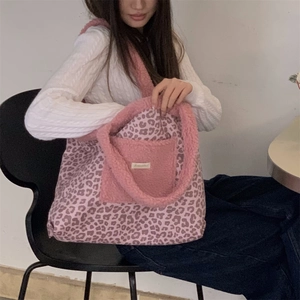 Detail view of pink leopard tote bag featuring plush trim and internal fleece pocket