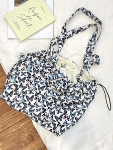 Large white butterfly print shoulder bag with drawstring closure and spacious interior