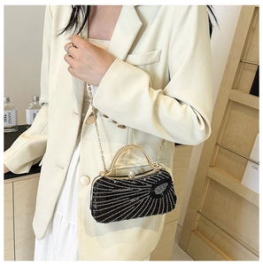 Macro detail of sparkly black rhinestone evening bag with elegant golden arch handle